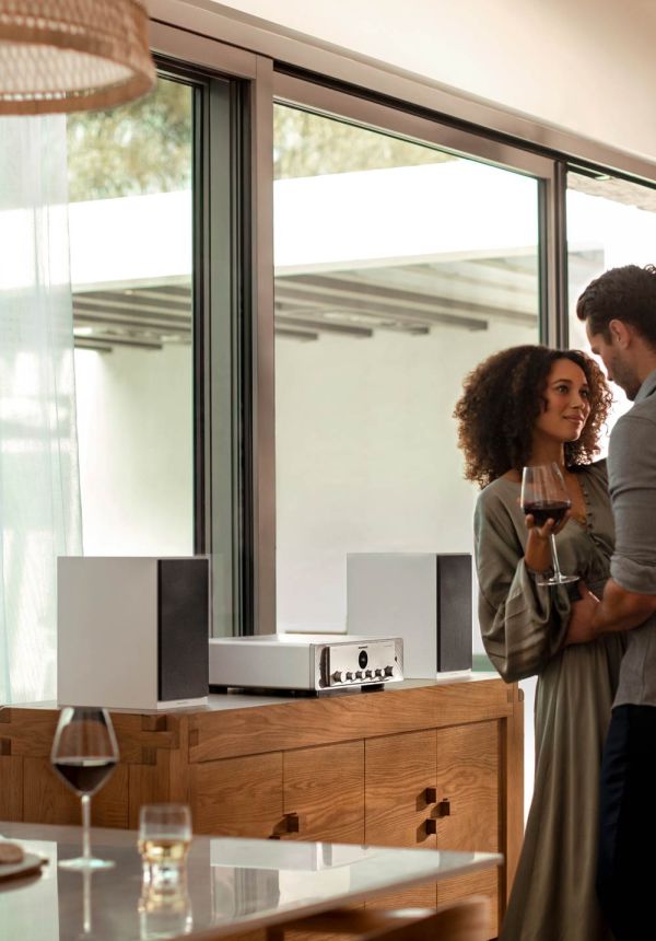 Couple dancing in living room while holding a glass of wine